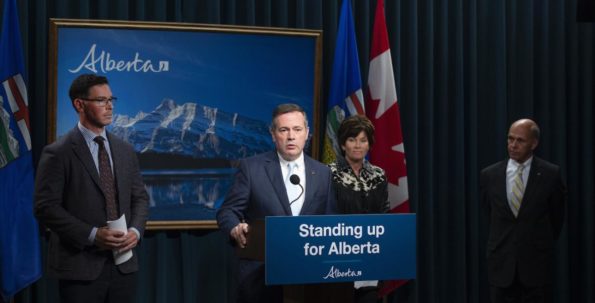 Premier Jason Kenney (at the podium) announces the appointment of Steve Allan (right) as Commissioner of the Public Inquiry into Anti-Alberta Energy Campaigns.Also pictured are then-Justice Minister Doug Schweitzer and Energy Minister Sonya Savage.
