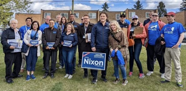 Jeremy Nixon (centre with the lawn sign) and UCP MLAs and volunteers in Calgary-Klein.