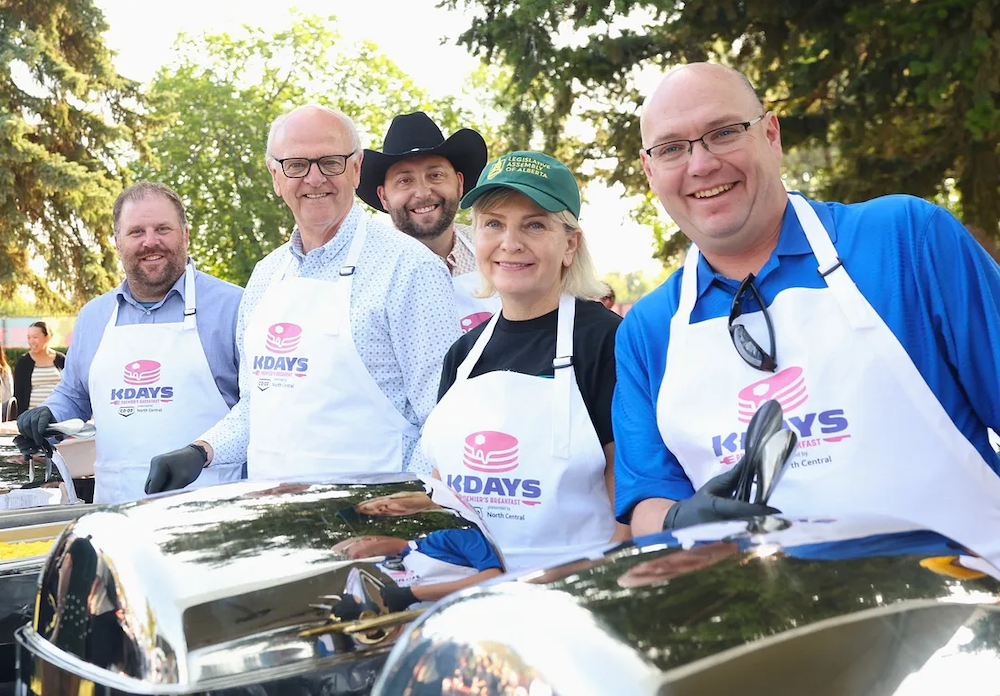 UCP MLAs Brandon Lunty, Ron Wiebe, Justin Wright, Jackie Lovely and Searle Turton at the Premier’s K-Days BBQ in 2025. Wiebe, Wright, Lovely and Turton are among the 26 MLAs facing recall campaigns (source: United Conservative Caucus / Facebook)